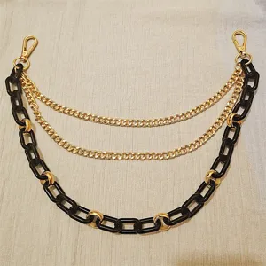 Detailed shot of multi-layer metal resin chain strap, versatile punk style bag and pants accessory.