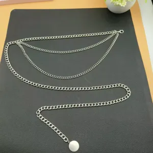 Detailed view of multi-layer silver metal waist chain, vintage body chain accessory for women.