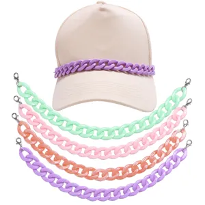 Detailed view of colorful acrylic hat chains and a beige baseball cap, trendy DIY accessories.