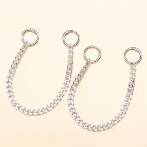 Close-up detail of silver metal shoe chain with round spring ring accessory decor.
