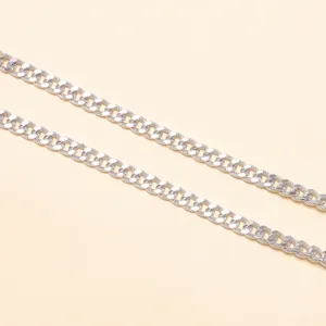 Closeup view of silver metallic chain details, showing textured surface for stylish accessories.