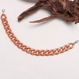Brown acrylic chunky chain detail shot, decorative accessory link with lobster clasps.