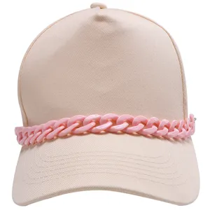 Close-up detail of stylish baseball cap featuring chunky pink chain decoration, trendy streetwear.