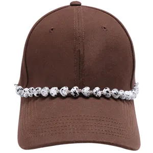 Fashionable brown baseball cap with black and white speckled heart acrylic bead chain decor.