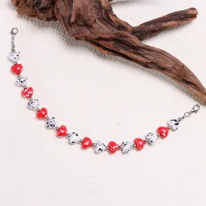 Detailed close-up of colorful heart-shaped beaded cap chain accessory with lovely design.