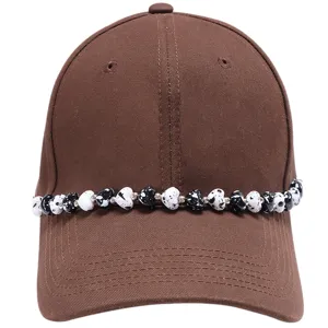 Brown baseball cap with black and white heart beaded chain accessory, trendy hat chain decoration.