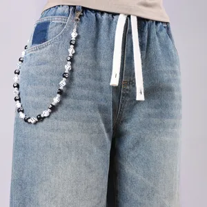 Modische Jeanshose mit einer einzigartigen schwarzen 8-Ball und Würfel Perlenketten-Detail für Streetwear.