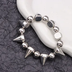 Close-up detail of the punk style metal choker necklace featuring metallic sphere beads and cone spikes.
