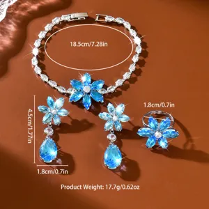 Superbe ensemble de bijoux fleur zircone larme comprenant bracelet, boucles et bague.