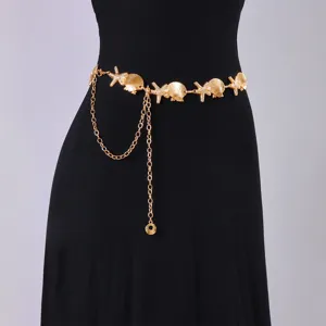Close-up of gold metal waist chain featuring seashell and starfish charms with pearl accents.