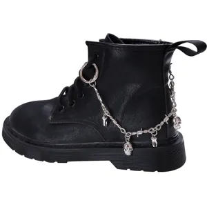 Black combat martin boots detail featuring punk style metal skull charms and chain accessories.