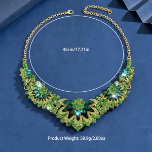 Detailed close-up view of the flower necklace featuring green rhinestones and gold finish.