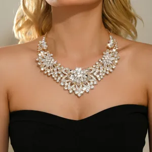 Close-up shot of a stunning rhinestone flower statement necklace on neck, sparkling crystals.