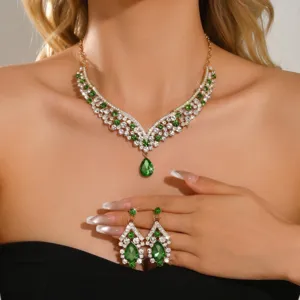 Detailed view of luxury green teardrop crystal necklace and earrings jewelry set shiny rhinestone