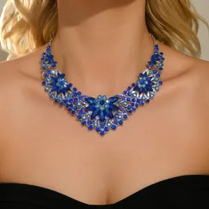 Stunning rhinestone flower statement necklace detail showcasing sparkling blue crystals on silver tone.