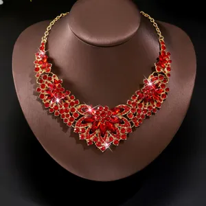 Close-up detail of luxury red rhinestone floral statement necklace, brilliant crystal sparkle.