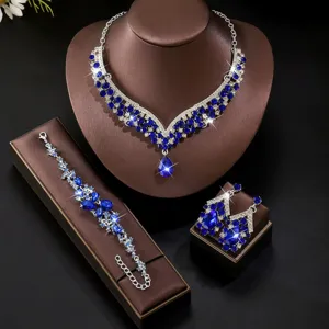 Stunning blue rhinestone jewelry set featuring necklace, bracelet and earrings for bridal gown.