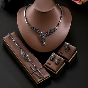 Completo set di gioielli con foglie in cristallo nero, collana, bracciale e orecchini.