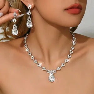 Close-up detail shot of luxury silver cubic zirconia teardrop necklace and earrings set.
