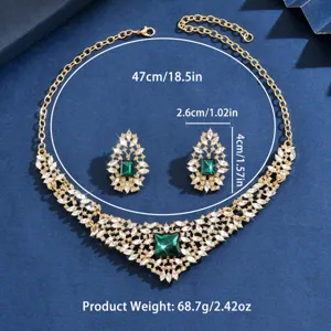 Vintage gold-tone crystal necklace and earrings set with green stone, elegant jewelry.