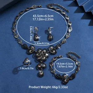 Dettaglio del set di gioielli gotico scuro con foglie di strass, collana, orecchini e anello.