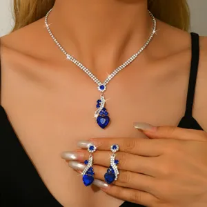 Vista ravvicinata della splendida collana e orecchini con cuore in strass blu.