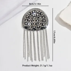 Rhinestone metal tassel shoulder epaulet detail, luxury stage costume accessory with sparkling crystals.
