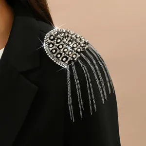 Close-up of luxury rhinestone metal tassel epaulet detail on black blazer for costume.