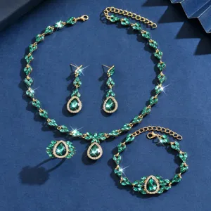 Detailed close-up of luxury green crystal jewelry set including necklace, earrings, bracelet.