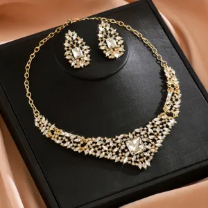 Detailed close-up of luxurious crystal necklace and earrings set showcasing dazzling rhinestones.