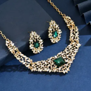Detailed close-up of the vintage rhinestone necklace and earrings jewelry set, green crystal.