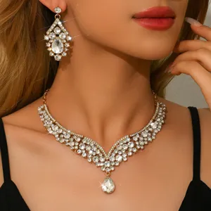 Close-up detail of luxury rhinestone crystal necklace and drop earrings set for evening party.