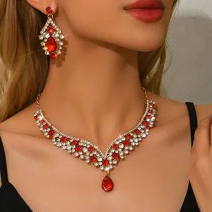 Luxury vintage red crystal rhinestone statement necklace and earrings jewelry set detail.