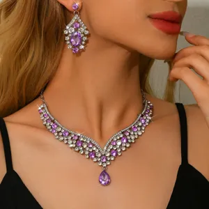 Close-up detail of luxurious purple rhinestone crystal necklace set with elegant design.