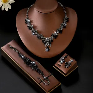 Vista dettagliata del set di gioielli con collana, bracciale e orecchini di foglie in strass.