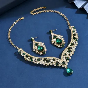 Close-up of luxury green crystal rhinestone necklace and earrings set for evening party wear.