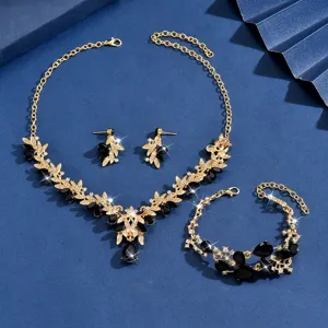 Elegante set collana orecchini bracciale con foglie dorate e cristalli neri per le donne.