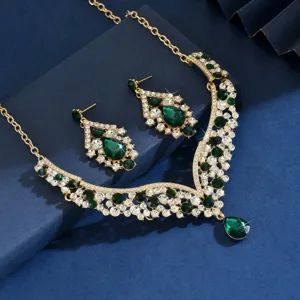 Detailed view of the luxurious vintage emerald green teardrop rhinestone necklace and earrings set.