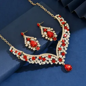 Detailed closeup of luxurious vintage red crystal rhinestone necklace and earrings jewelry set.