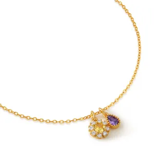 Gold chain necklace with yellow and purple zircon flower pear pendants detail close-up