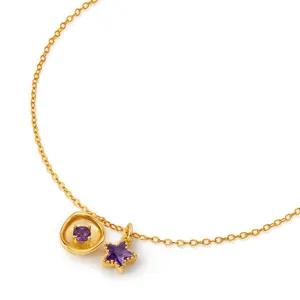 Gold necklace detail featuring purple zircon round and star pendants, exquisite jewelry.