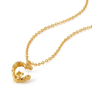 Elegante collar con colgante irregular dorado y circonita amarilla brillante para mujeres.