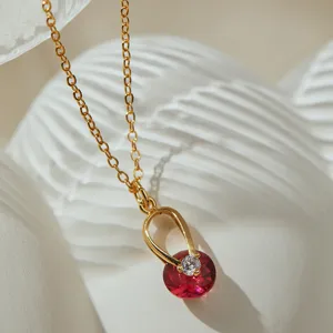 Gros plan exquis de collier de clavicule en pierre rouge, plaqué or 18k, zircon étincelant.