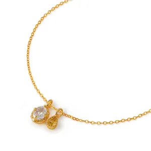 Exquisite detail view of gold-plated chain necklace featuring dual sparkling cubic zirconia pendants.