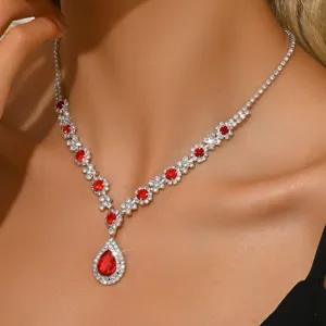 Detailed view of silver teardrop red crystal necklace, featuring sparkling rhinestone clusters.