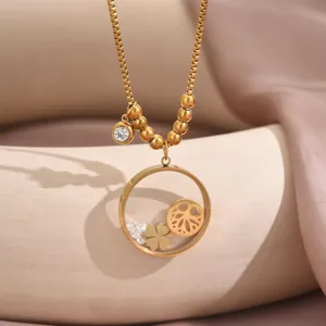 Close-up detail of the gold-plated titanium steel floating locket necklace with clover charm.