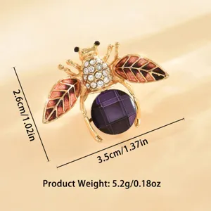 Spilla a forma di ape color oro con strass e dettaglio di pietra viola bigiotteria