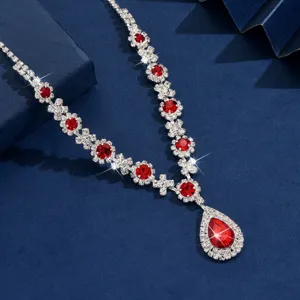Silver-tone alloy necklace featuring vibrant red crystal rhinestones and a striking pendant detail.