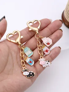 Cute cartoon cow milk bottle metal keychain with heart lobster clasp and enamel charms.