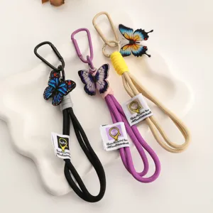 Llavero trenzado de nailon con dije de mariposa cordón para teléfono al aire libre
